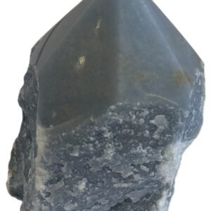 Natural rough angelite freeform with polished point 2 sians emporium Natural rough angelite freeform crystal with unpolished sides and a smooth polished blue point standing on a white background